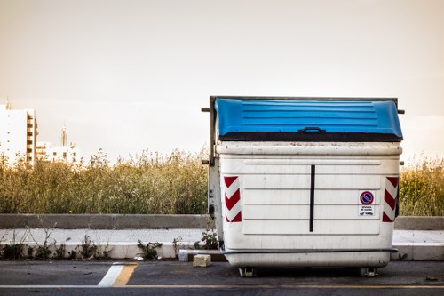 Front view of a cleared residential property with removal truck in background