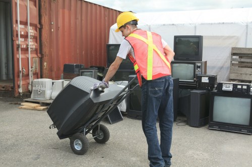 Waste clearance workers sorting construction materials